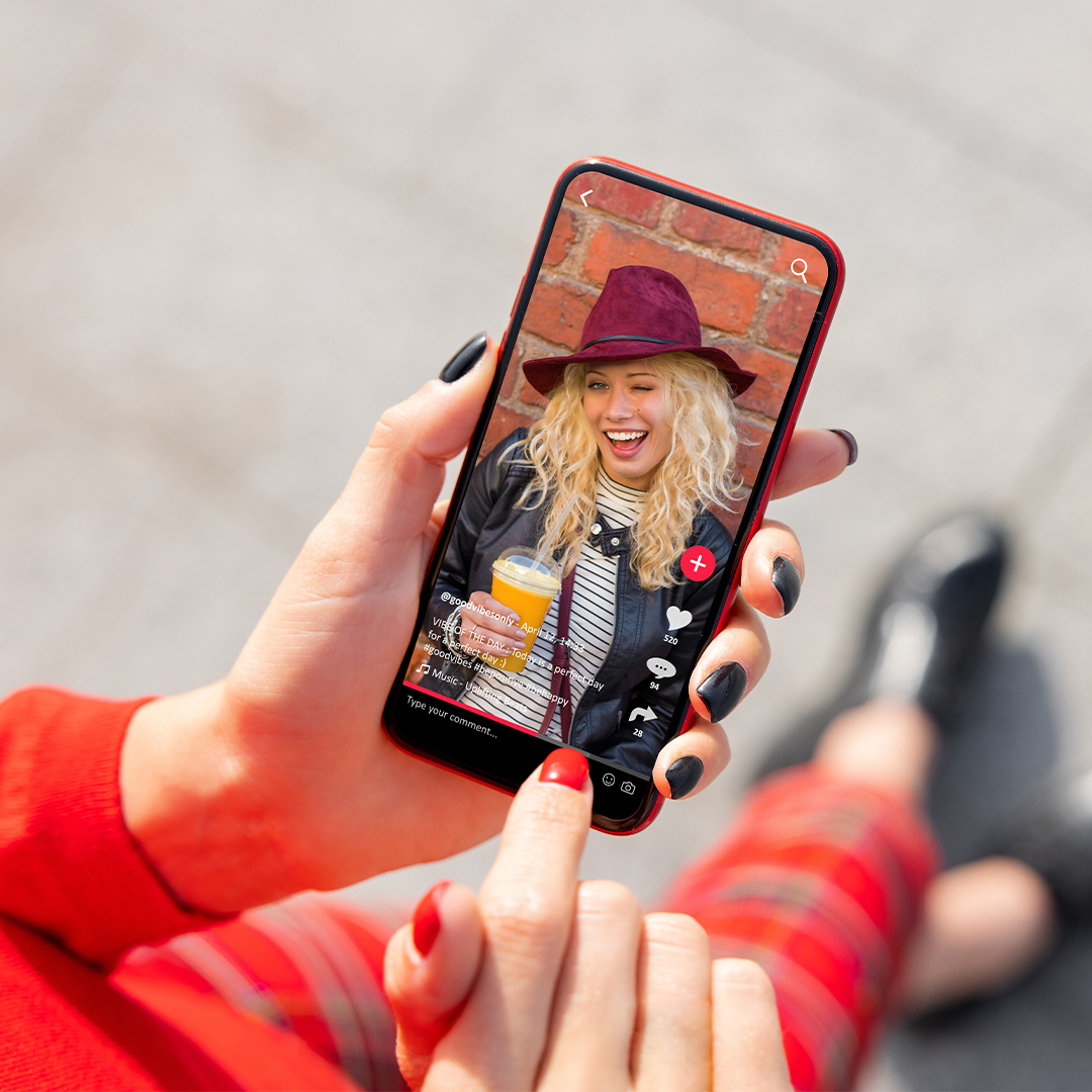 Weibliche Hände halten ein Smartphone mit TikTok. DGK_TikTok-_-Datenschutz-header.jpg